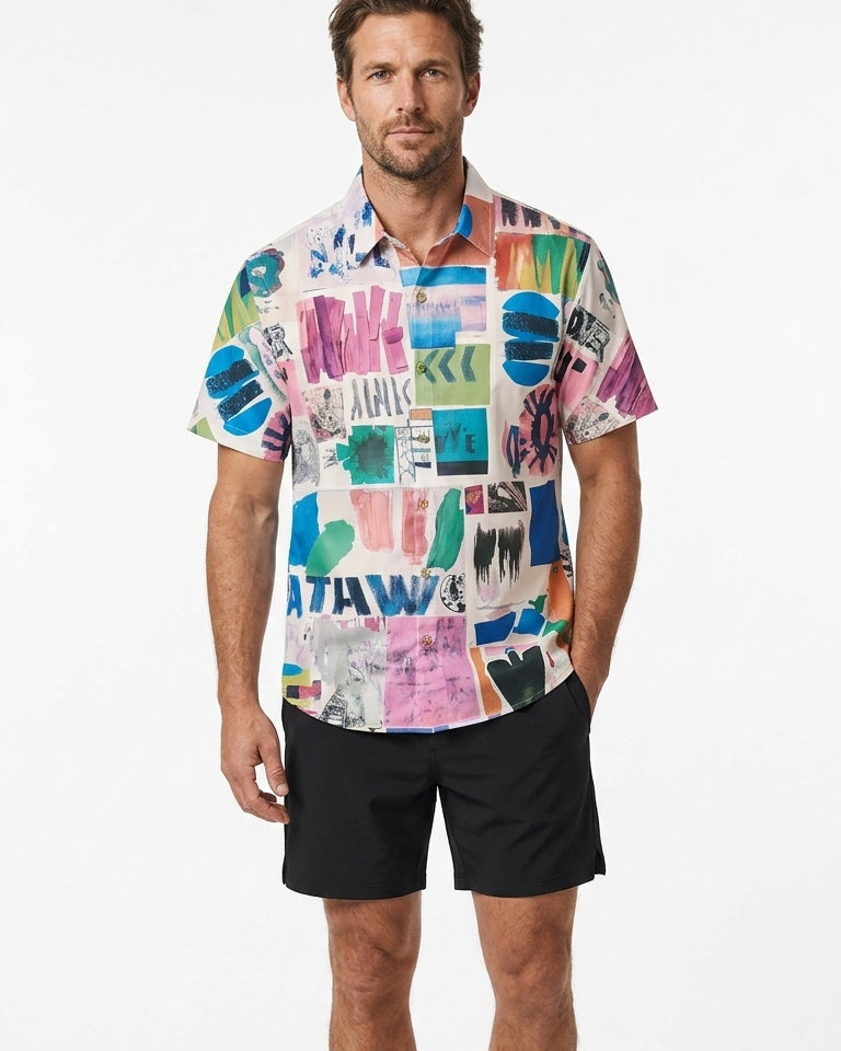 Man wearing a colorful patterned shirt and black shorts on a white background