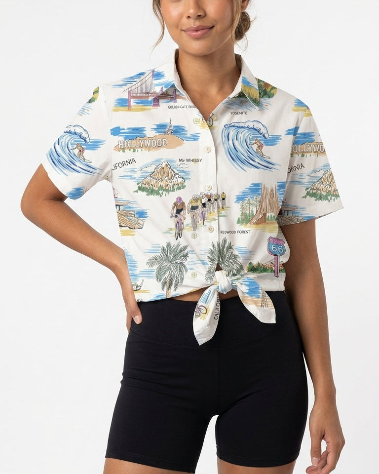 Woman wearing a colorful patterned shirt with a white background